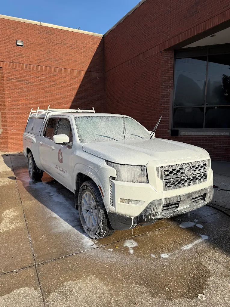 Commercial pickup truck covered in foam during detailing